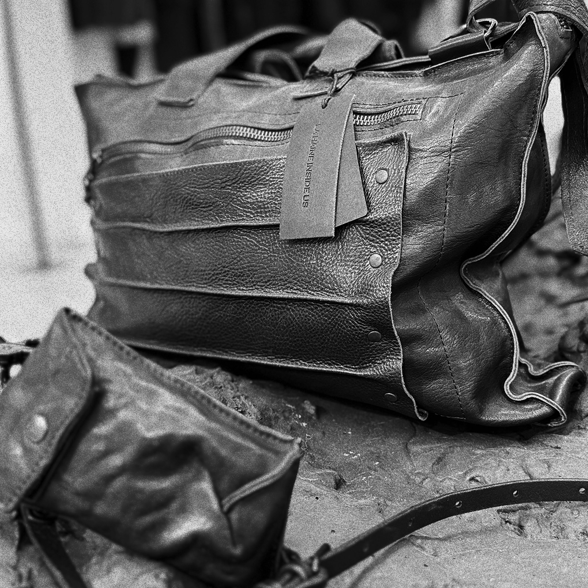 Close-up of black leather object, stitching and textured display surface